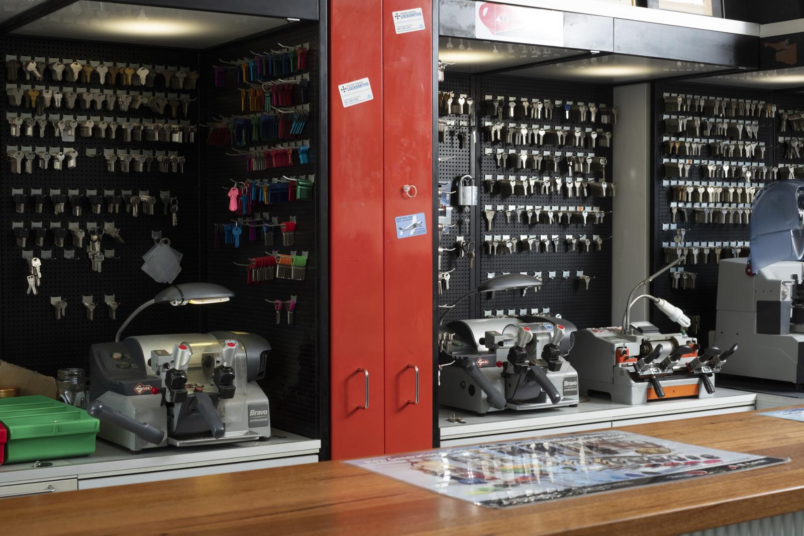 Key cutting counter with key blanks, machines and locksmith tools in a shop