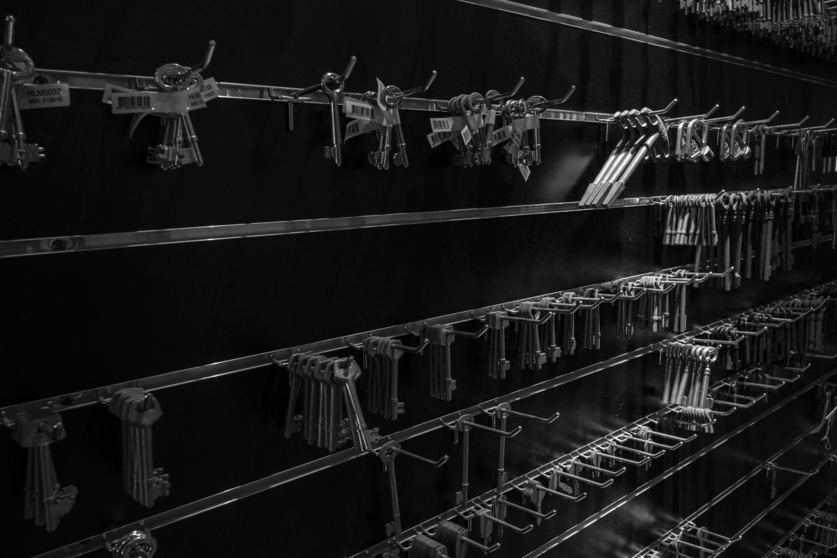 Rows of key blanks hanging on racks in a locksmith key cutting shop