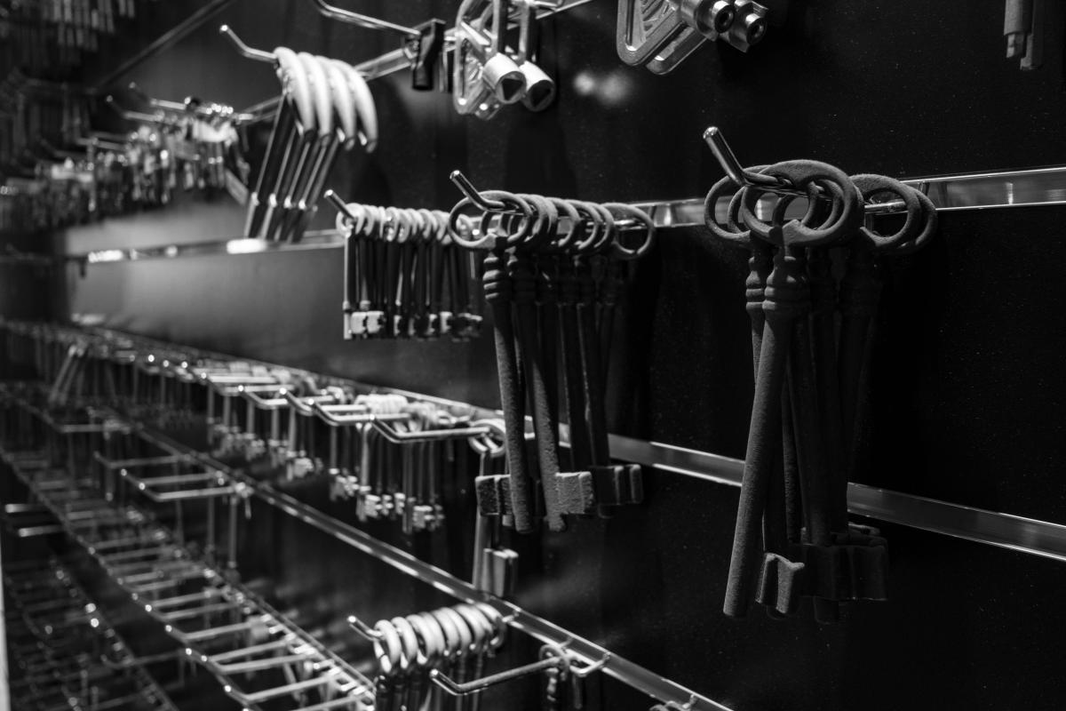 Rows of keys hanging on a rack in a locksmith key cutting shop