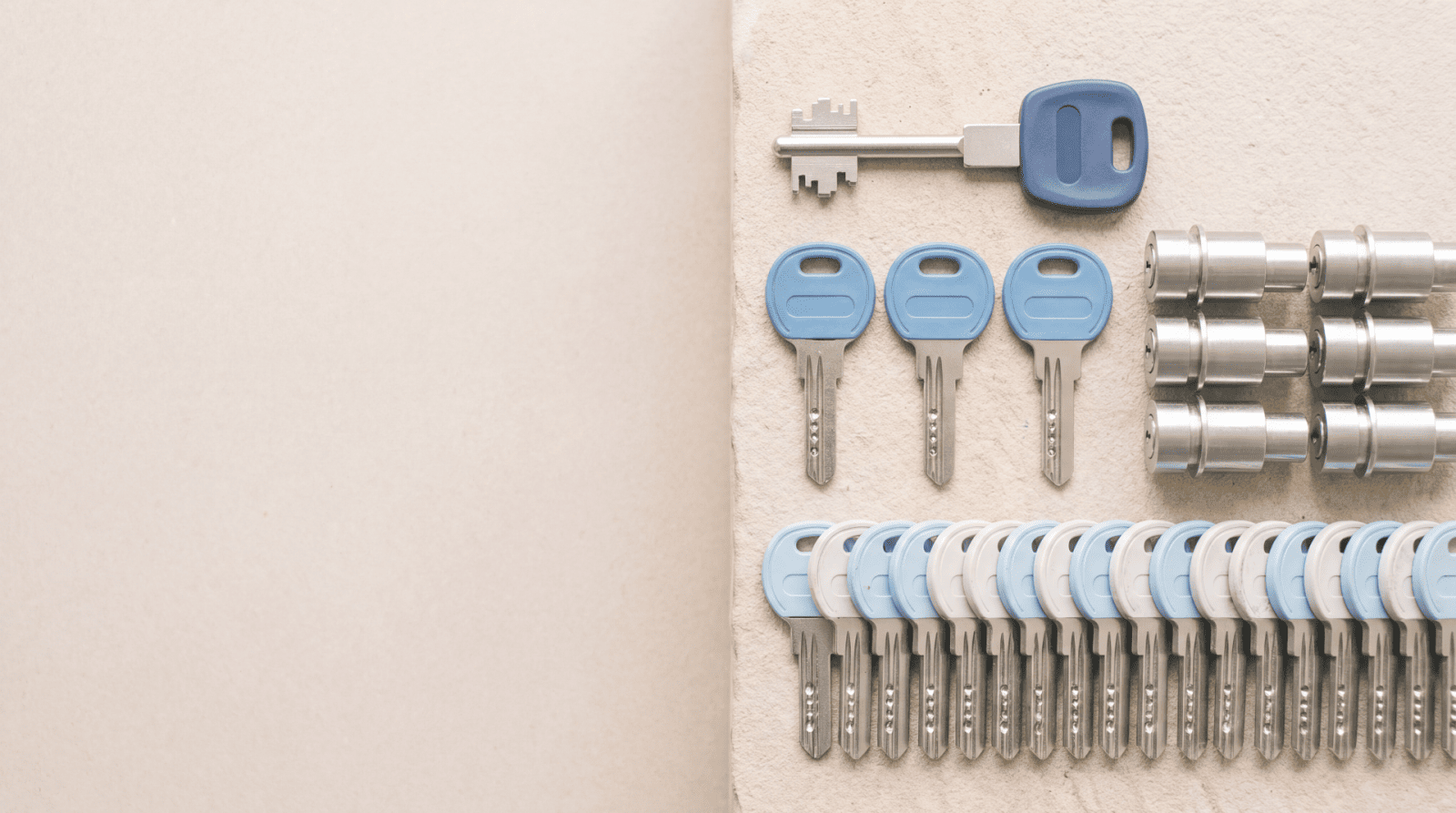 Organised sets of security keys and lock cylinders on a wall-mounted key board